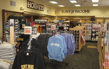 Interior image of bookstore featuring school clothing.