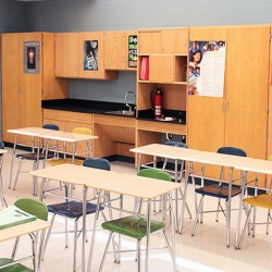 Interior image of school classroom featuring desks and chairs.