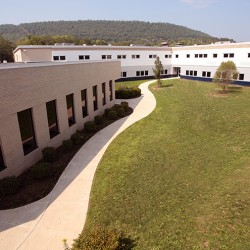 Exterior image of side building featuring sidewalk.