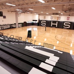 Interior image of school gymasium featuring wood floor.