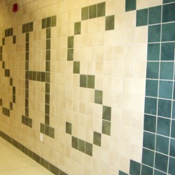 Close up image of interior hallway tile on wall.