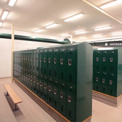 Interior image of locker room with green lockers.