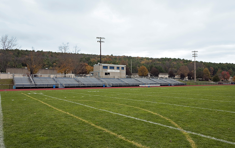 Exterior image of turf field, bleachers and homestand.