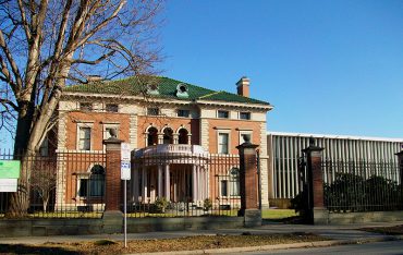 Exterior image of front entrance of Roberson Museum surrounded by iron gate.
