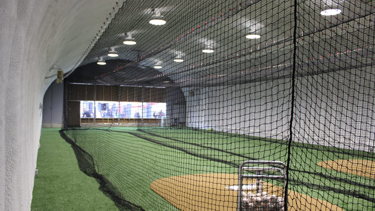 Batting cage at Mirabito Stadium, formerly NYSEG Stadium, featuring nets, turf flooring, and warm-up space for Binghamton Rumble Ponies.