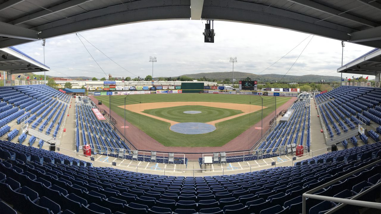 Panoramic view of the field at Mirabito Stadium, formerly NYSEG Stadium, captured from the upper deck with a sweeping look at the playing field, seating bowl, and surrounding stadium environment.