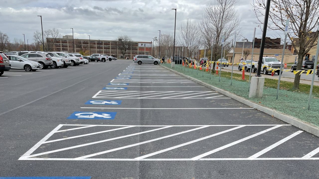 View of the parking lot at the Nexus Center in Utica, NY, featuring marked spaces designed for accessibility and convenience, supporting the tournament-based recreation facility.